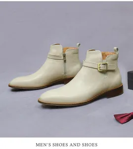 Detail of cream leather men's dress boot featuring a metal buckle strap and side zipper