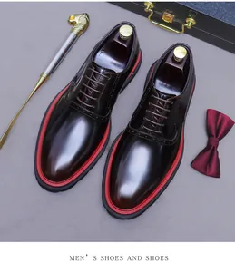 Detail of burgundy leather oxford shoes with brogue patterns and red thick soles