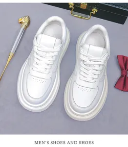 Overhead view of white leather men's sneakers with thick soles and premium styling