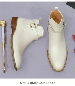 Detail view of apricot leather boots featuring metallic buckles and side zipper closure