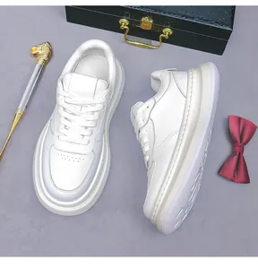 Detailed close-up of men's white leather platform sneakers with breathable perforations