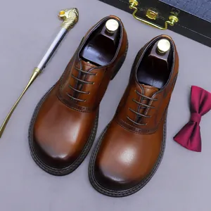 Brown leather brogue oxford shoes with gradient burnished toe and classic wingtip detail