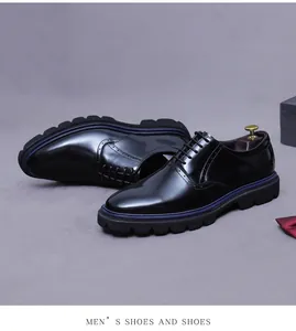 Detail of black leather oxford shoe with brogue patterns and blue decorative welt line