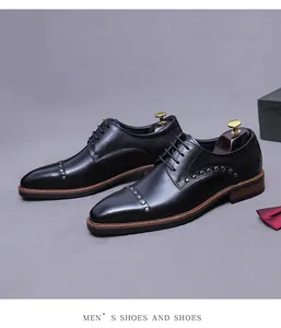 Top view of black leather formal shoes with metal studs and luxury shoe tree accessories