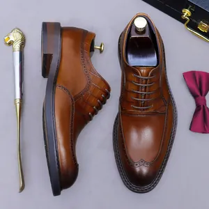 Premium men's dark brown leather brogue shoes with crocodile pattern and wingtip carving