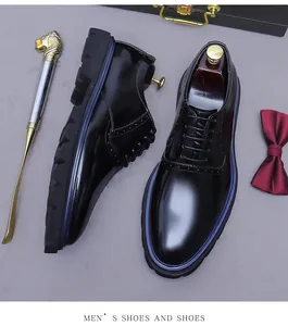 Macro view of black patent leather oxford shoes with brogue details and slip-resistant sole