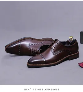 Detail of brown leather oxford shoes with silver studs and elegant gradient toe cap
