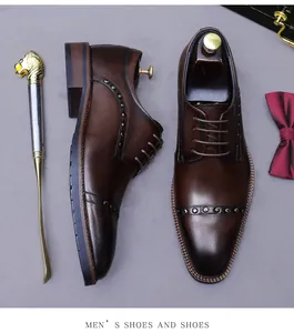 Close-up of brown leather dress shoes with metal rivets and vintage gradient finish