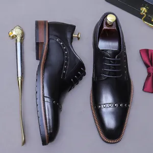 Men's leather dress shoes with silver studs and wooden heel on a business background