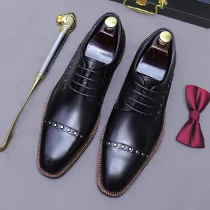 Polished black leather oxfords for men with silver rivet accents and classic three-joint design