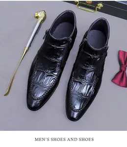 Detail of black crocodile embossed leather boot with side zipper and luxury gift items