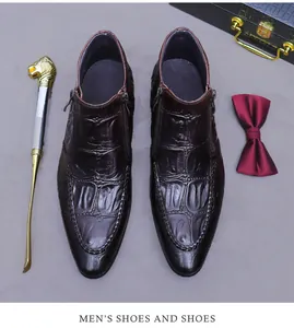 Detail of embossed leather boots with side zippers, shoe horn, and formal accessories