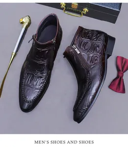 Detail of embossed crocodile leather texture and metal zipper on brown men's dress boots
