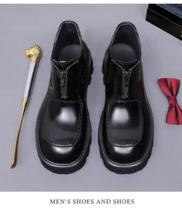 Top view of men's leather brogue boots with side zipper and wingtip carved details