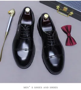Close-up of black patent leather brogue shoes with elegant wooden shoe trees inside