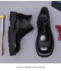 Detail of men's black patent leather brogue boots with front zipper and thick sole