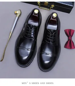 Top view of polished black leather brogue shoes with decorative perforated details