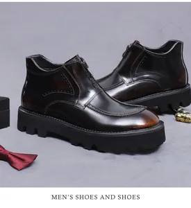Detail of dark brown leather boots with front zipper, brogue detailing and thick soles