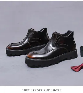 Detail view of men's leather boots with front zipper and vintage brogue stitching