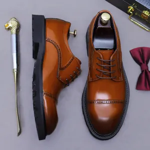 Men's brown leather brogue derby shoes with classic wingtip carving and thick rubber sole