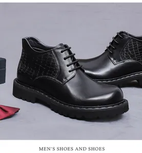 Detail of men's black leather boots with crocodile embossed pattern and thick lug sole