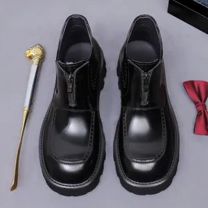 Men's glossy black leather boots with front zipper, chunky sole, and round toe design