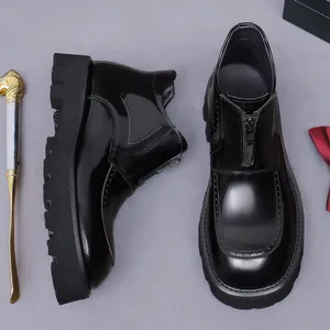 Polished black leather platform boots for men with front zipper and rugged rubber sole