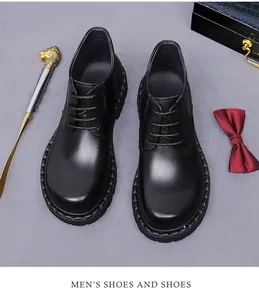 Top-down view of black leather business boots with laces on textured background