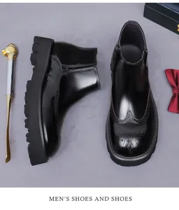 Detalle de botas Chelsea de cuero negro brillante con motivos brogue tallados