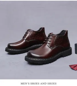 Detail view of burgundy leather boots with crocodile embossed texture and non-slip rubber soles