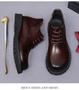 Detail of men's dark brown leather shoes featuring embossed crocodile pattern texture