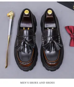 Close-up of retro tassel loafers with gradient brown leather and gold lion shoehorn