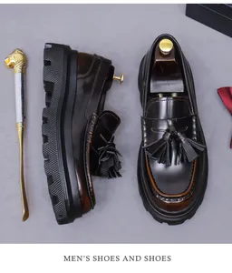 Top view of dark brown leather tassel loafers with thick serrated soles and shoe horns