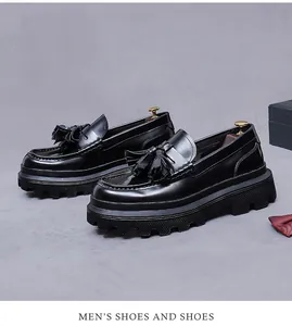 Detailed macro view of black patent leather loafers with classic tassel and thick rubber sole