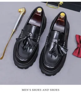 Top-down view of black leather tassel loafers with thick non-slip soles and premium box