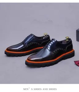 Detail of genuine leather shoes featuring metal studs and thick orange-trimmed rubber soles