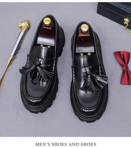 Polished leather tassel loafers with thick rubber soles and wooden shoe trees set