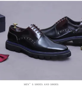 Detail of dark wine red leather shoe with metal rivets and blue midsole accent