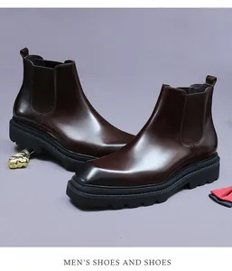 Detailed close-up of dark brown leather Chelsea boots with durable thick rubber soles