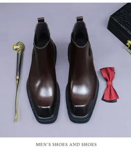 Overhead view of dark brown leather Chelsea boots with square toe and premium props