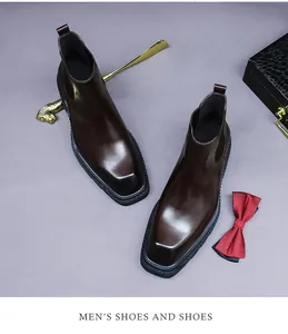 Close-up of square-toe men's dark brown leather dress boots with elegant formal accessories