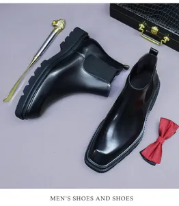 Detail of square-toe black leather Chelsea boot with elastic side and thick sole