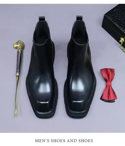 Top view of premium black leather Chelsea boots with square toe and elegant gift box set
