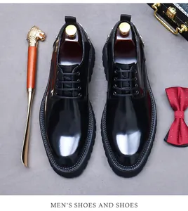 Flat lay of men's glossy black leather derby shoes with bowtie and accessories