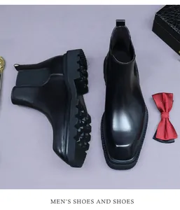 Detail view of black leather Chelsea boots featuring a lug sole and square toe design
