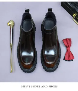 Detail of dark brown glossy leather Chelsea boots with side zipper and chunky rubber sole