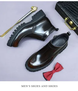 Detailed view of polished brown leather Chelsea boots with side zipper and thick soles