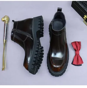 Top view of shiny dark brown leather boots with a lion shoehorn on purple background
