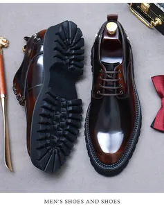 Detailed top view of brown gradient leather dress shoes with thick lug soles and metal studs