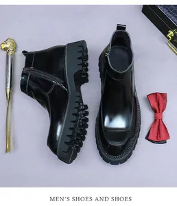 Detail of high-gloss black leather Chelsea boots with side zipper and rugged anti-slip sole